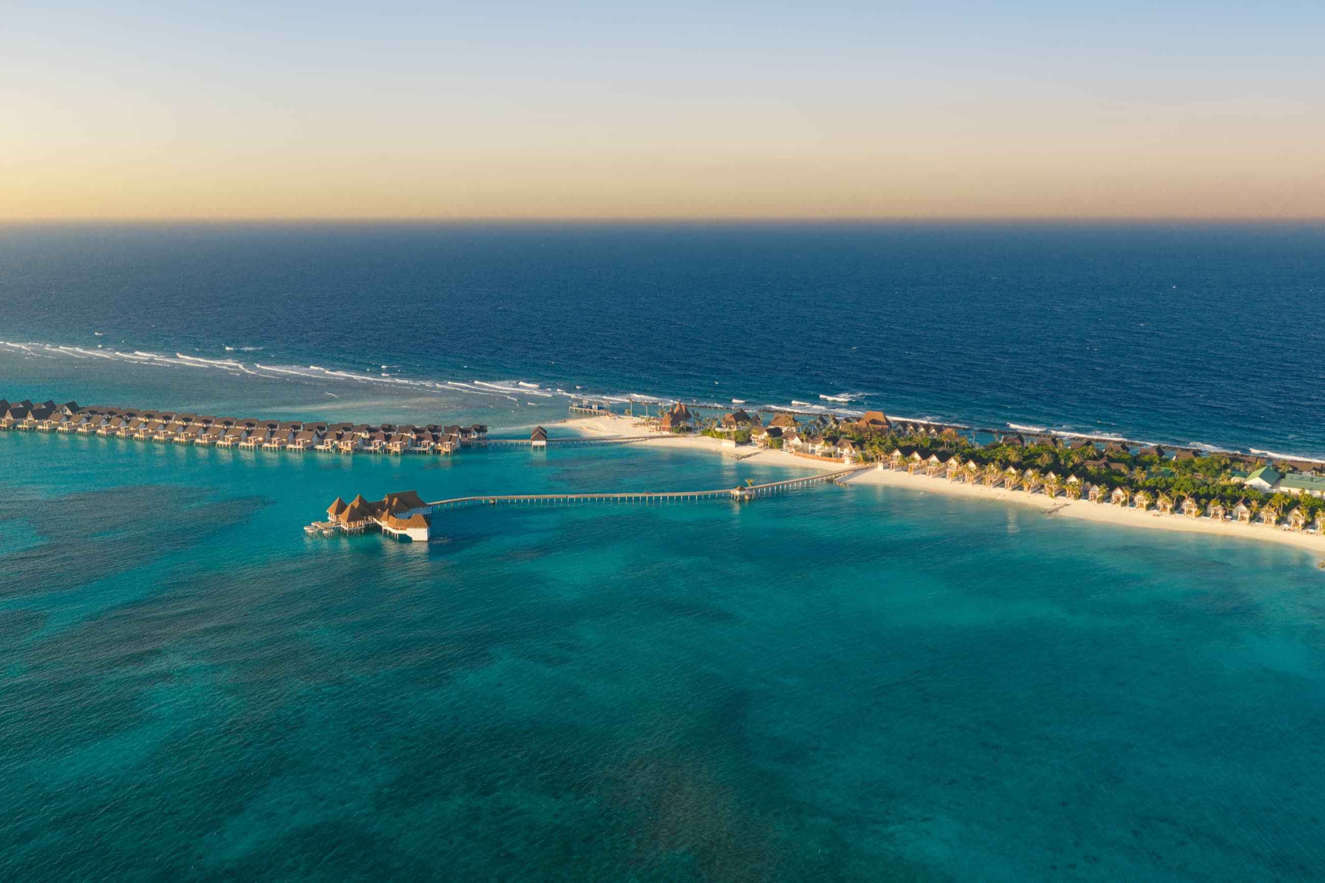 Meyyafushi from the air at sunset, overwater villas and the jetty